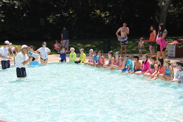 Kids wait for their turn to participate in a kickboard race