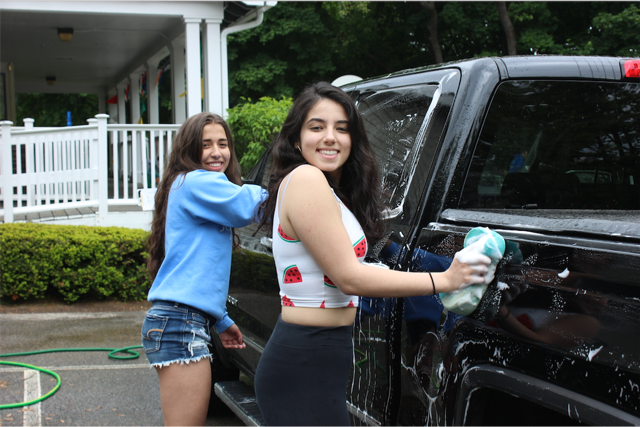 Erin Olender and Jenna Orrico working at the car wash